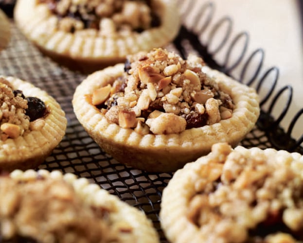 Mince pies with a streusel topping, shown in a tin