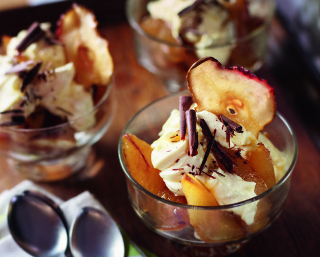 Pear trifles shown in glass bowls with spoons