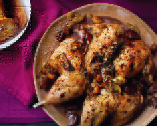 Spatchcocked roast chicken with chilli coating and tomato salad
