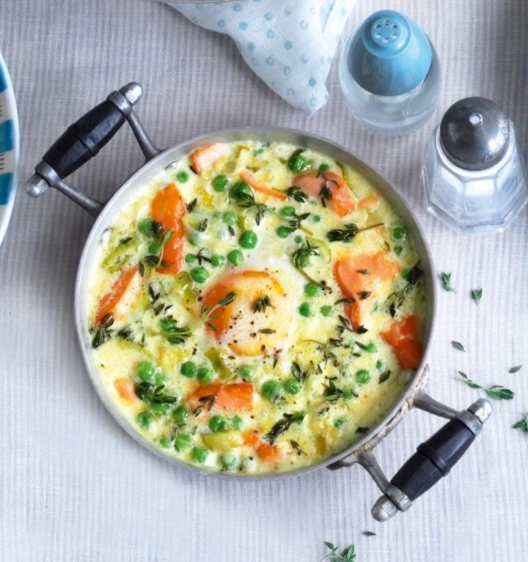 Eggs en cocotte with hot-smoked salmon, leeks and peas