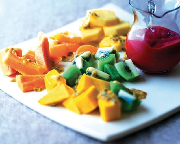 Tropical fruit salad on a plate - papaya, kiwi, mango