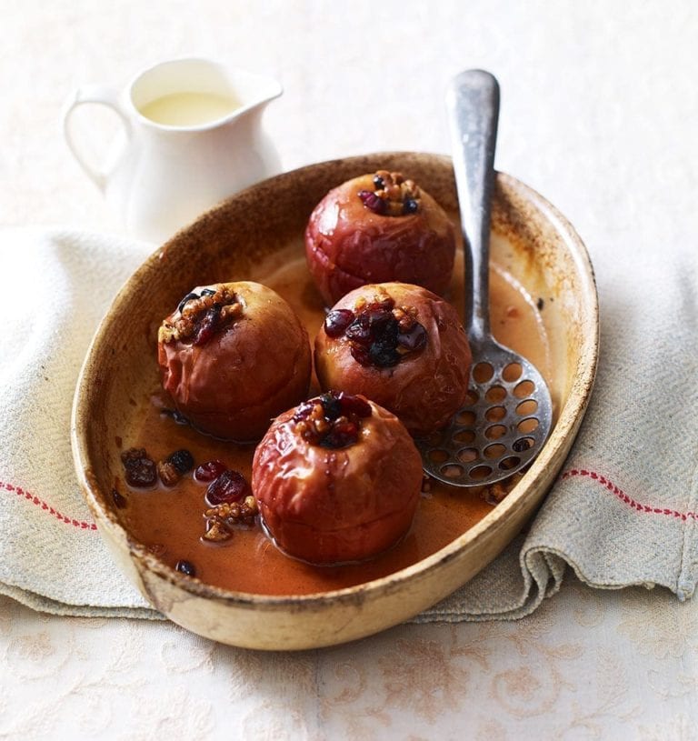Cinnamon and berry-stuffed baked apples with maple syrup