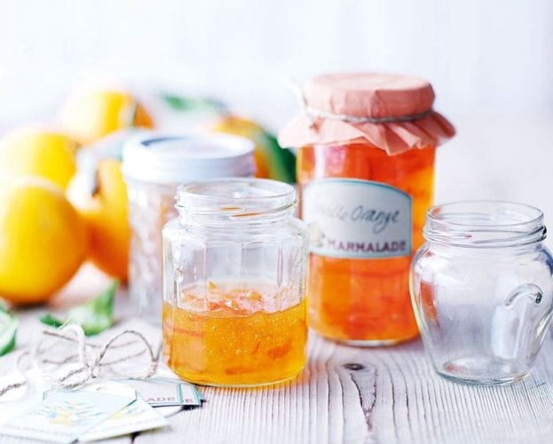 Seville orange marmalade shown in jars sitting on a white table. Image from Feb 2010 recipe