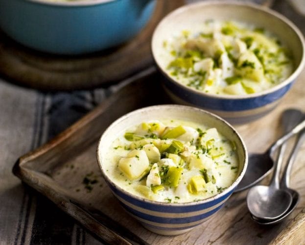 Smoked haddock, leek and potato chowder in two blue bowls