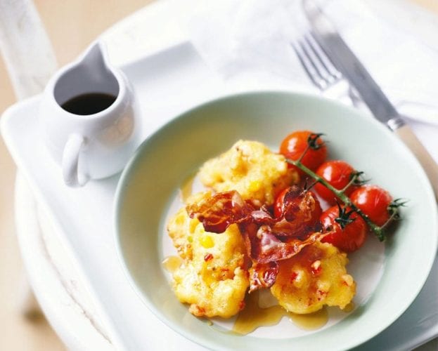 American corn fritters with bacon and roasted tomatoes