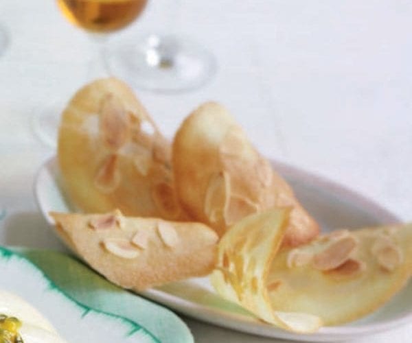 Almond tuiles shown in a small bowl