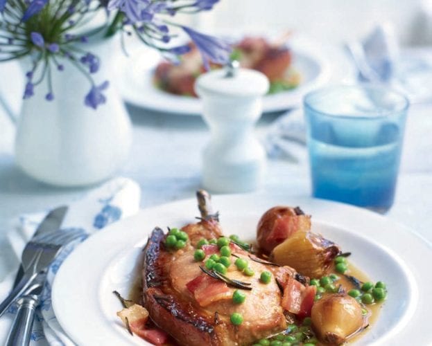 Pot-roasted pork chops in cider with shallots and peas