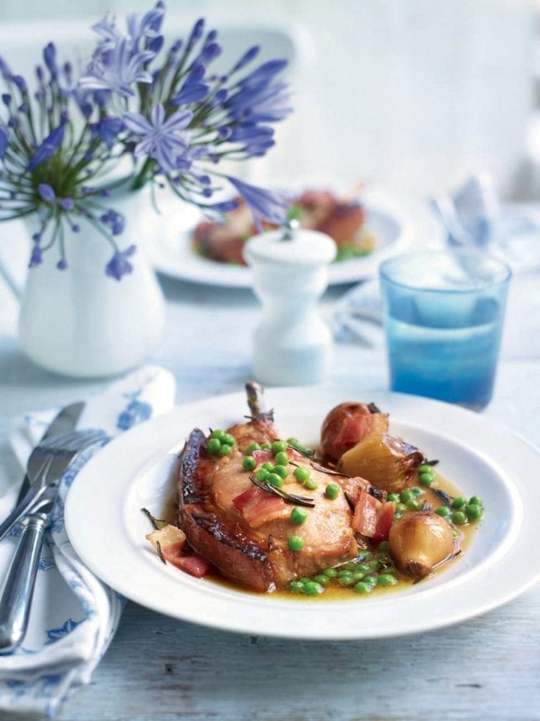 Pot-roasted pork chops in cider with shallots and peas