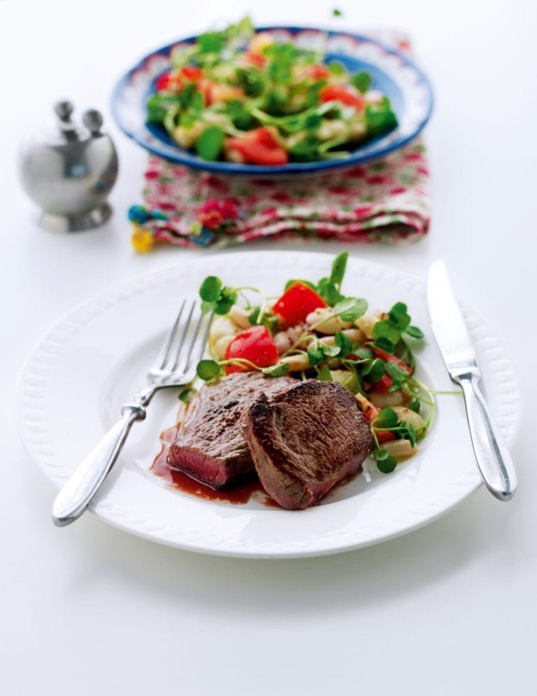 Seared steak with white beans and watercress