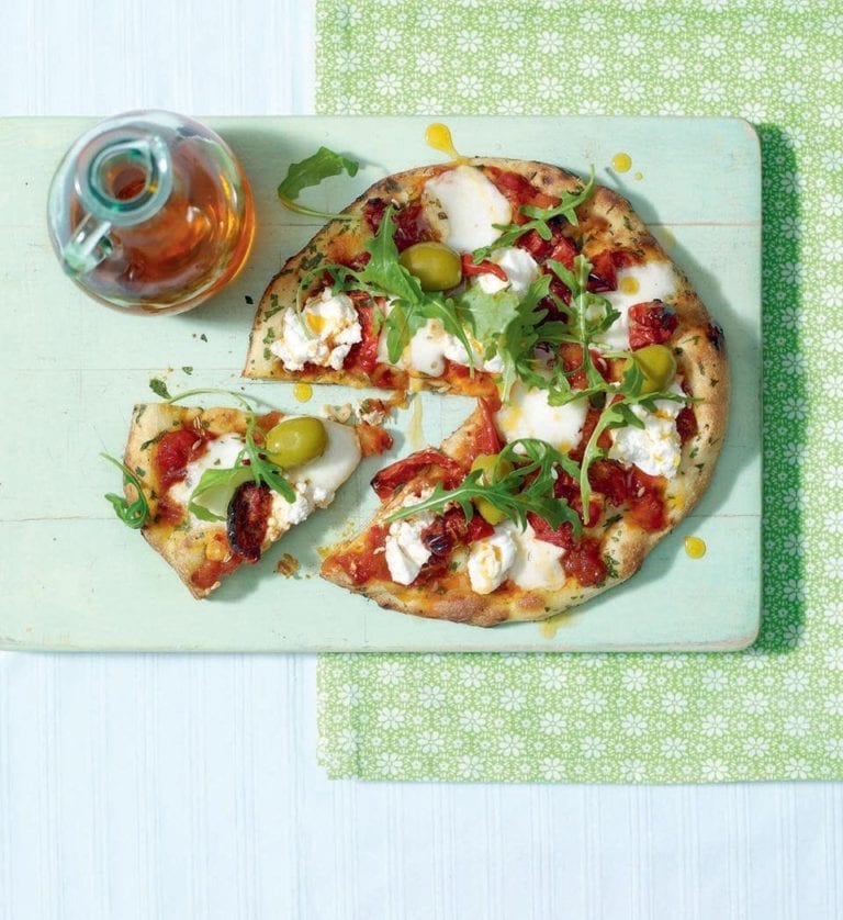 Pizza made with a naan base, shown with a slice cut out