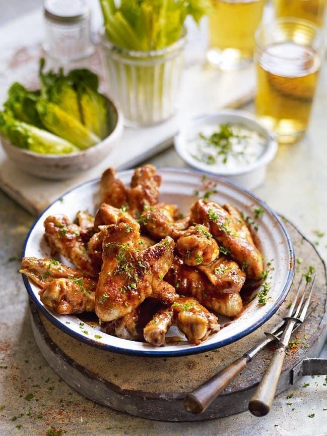 Buffalo chicken wings with celery sticks and blue cheese dip