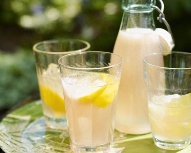 Homemade lemonade in bottles and glasses