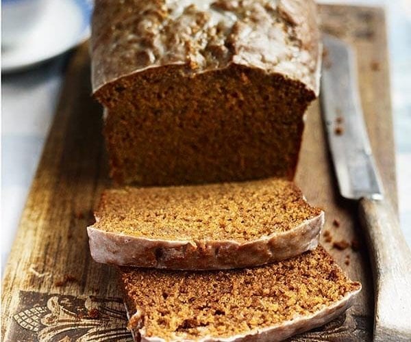 A finished honey loaf cake, with slices cut from it
