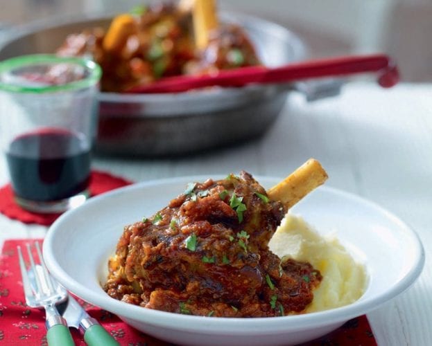 Curried lamb shanks in white bowls