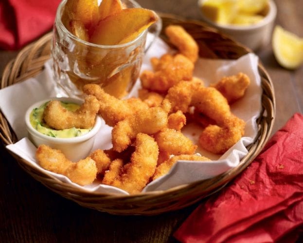 Homemade scampi and chips shown in a bowl