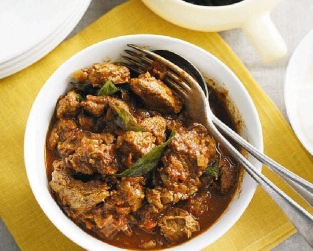 Beef vindaloo in a white bowl