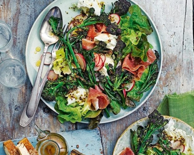 Salad with mozzarella and parma ham and purple sprouting broccoli, shown on a plate with a spoon