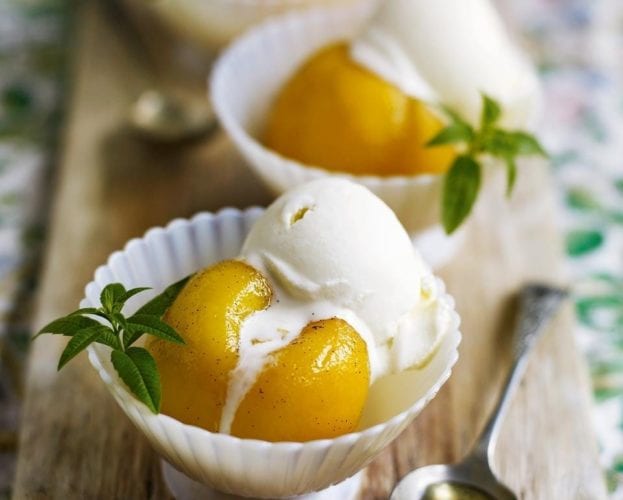 Peaches and ice-cream shown in small white bowls