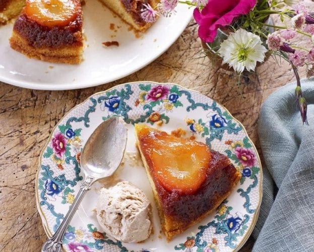 Upside-down pear cake with ice-cream on patterned plates