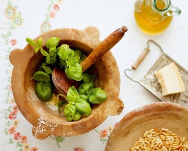 Basil leaves in a pestle and mortar