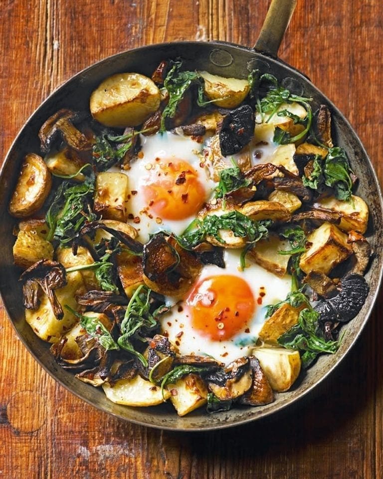 Baked eggs with mushrooms, potatoes, spinach and Gruyère