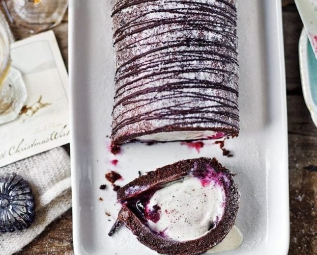 Chocolate and cherry arctic roll dessert shown on a white rectangular plate