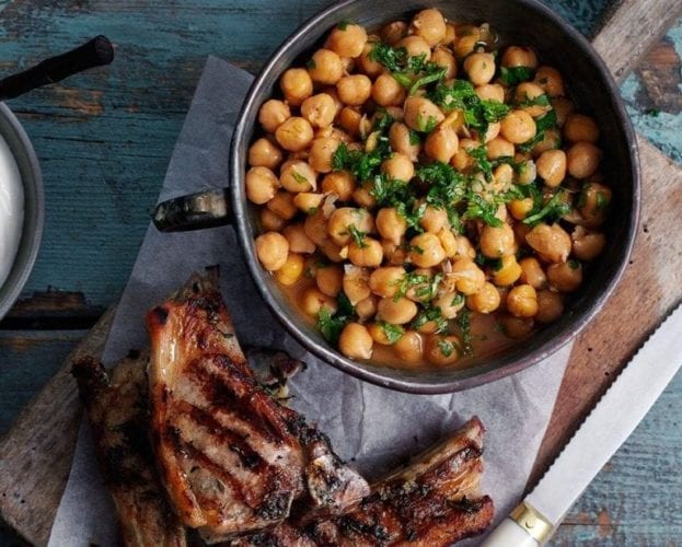 Lamb cutlets with chickpeas shown on a table
