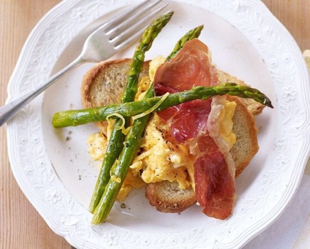 Roasted asparagus with scrambled egg and parma ham