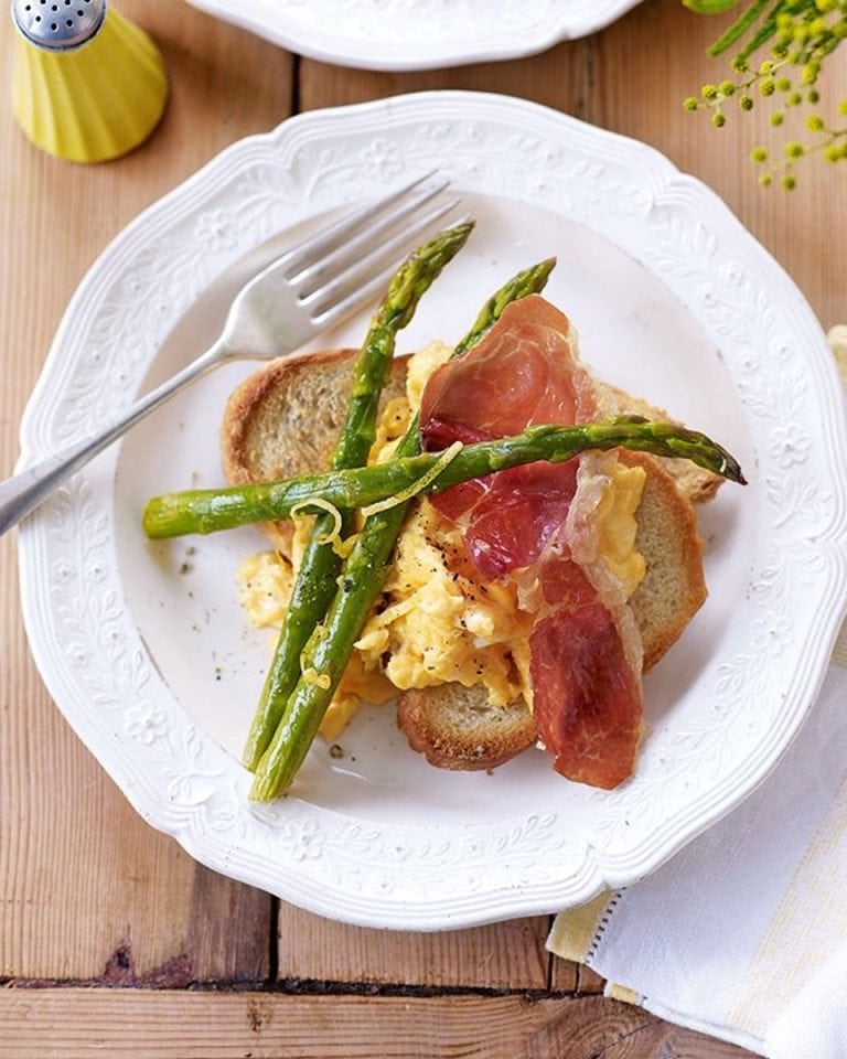 Roasted asparagus with scrambled egg and parma ham