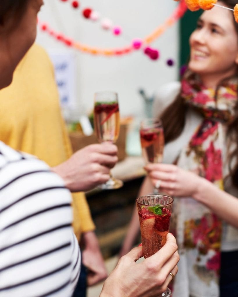 Image of people talking with drinks in hand