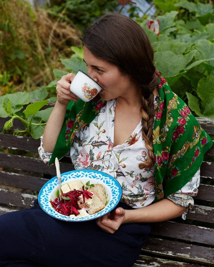 Image of Olia eating lunch and drinking tea in the garden