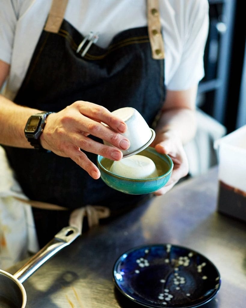 Image of chef Terry turning pannacotta out into a bowl