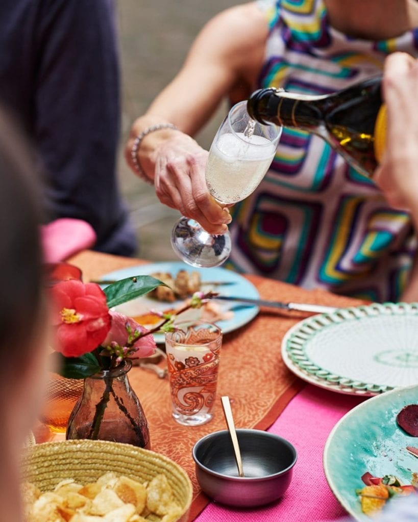 Image of a champagne flute being filled with prosecco