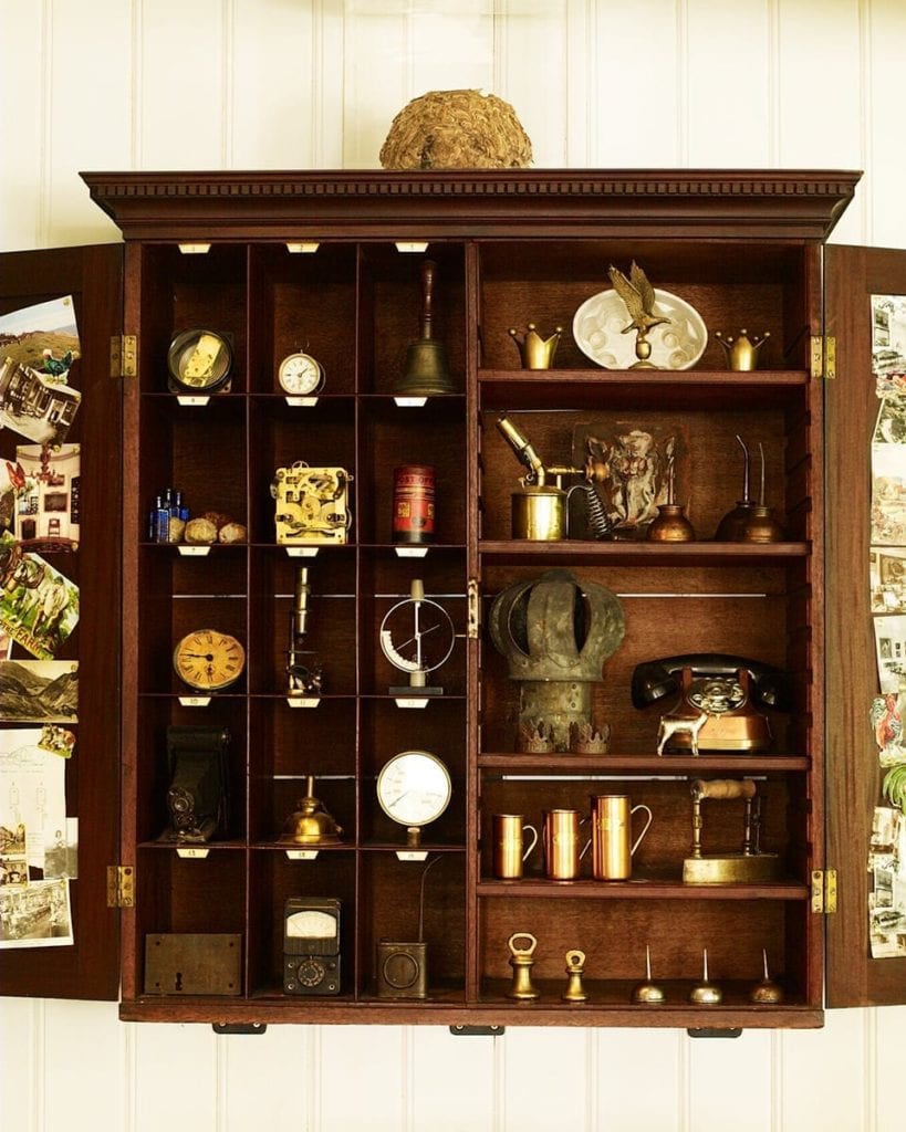 Image of an old cupboard filled with old racing cups