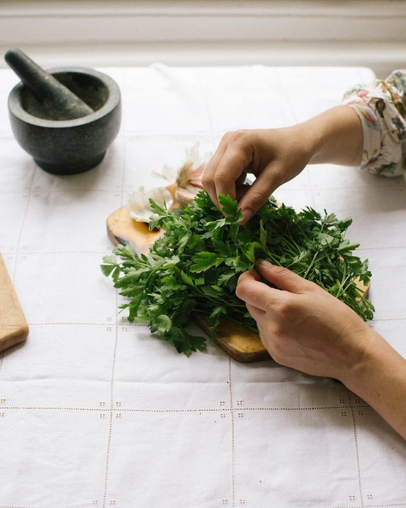 Image of Olia chopping herbs