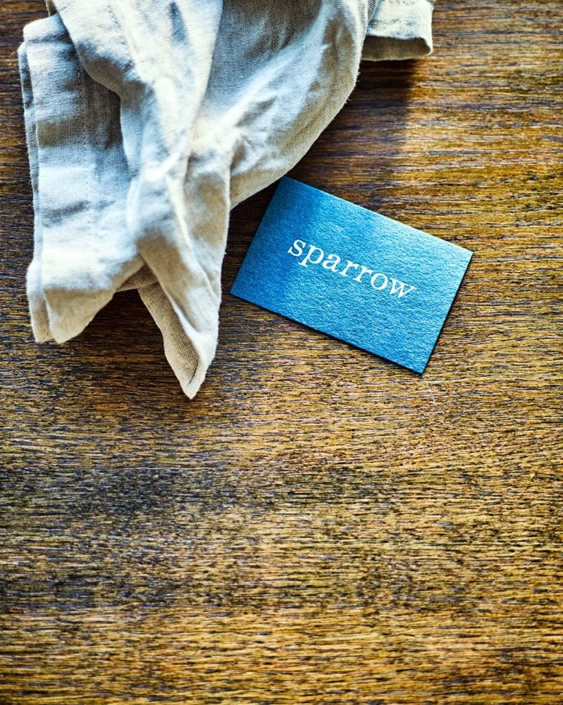 Image of a Sparrow business card and napkin on the table