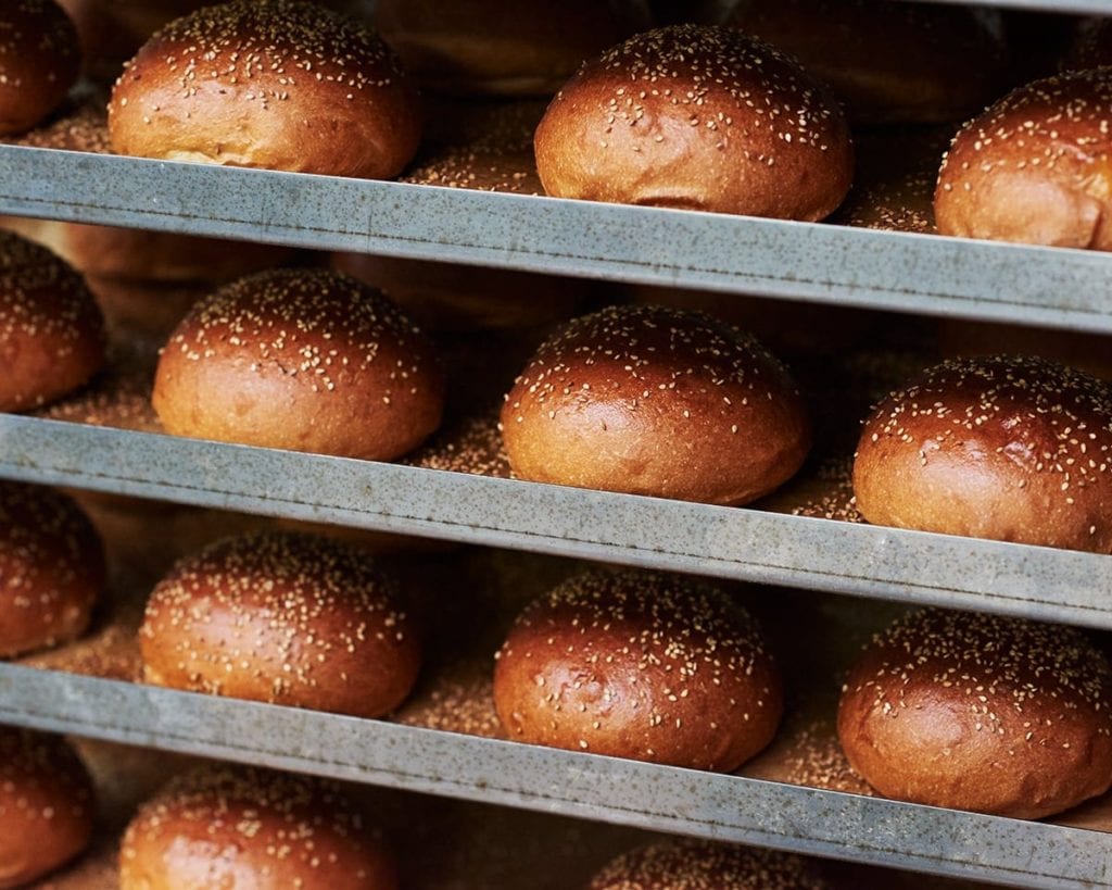 Image of shelves of sesame-topped bread rolls