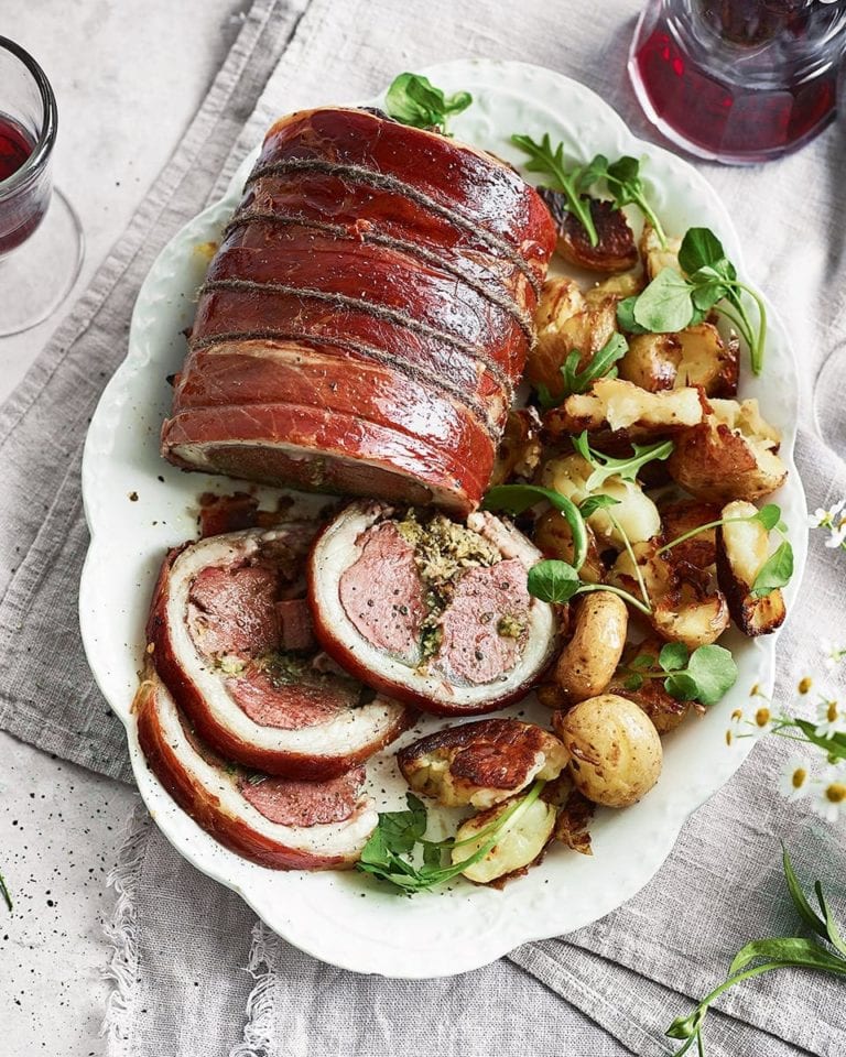 Herby stuffed saddle of lamb with crushed roasties
