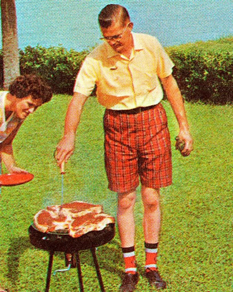 stock image of a man over a bbq