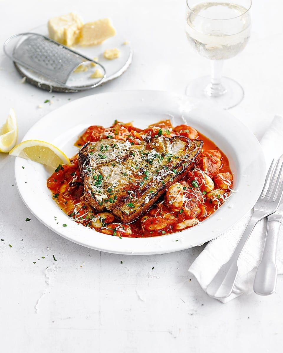 Pork chops with red pepper pesto baked beans recipe | delicious. magazine