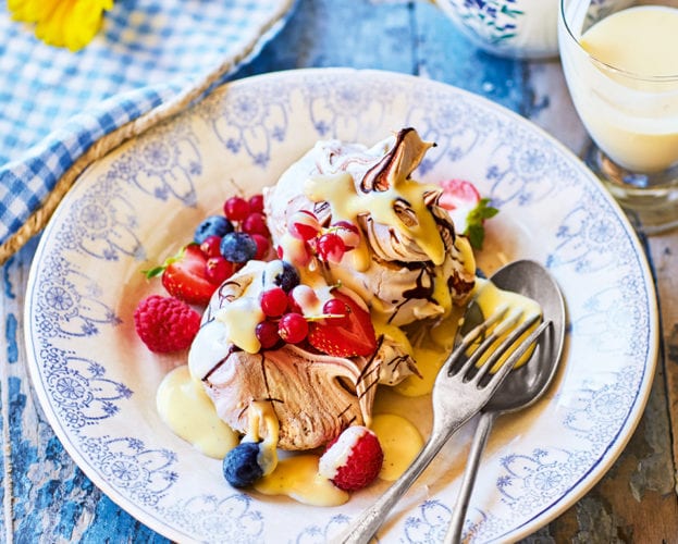 Chocolate swirl meringues, berries and white chocolate sauce