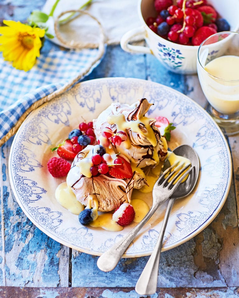 Chocolate swirl meringues, berries and white chocolate sauce