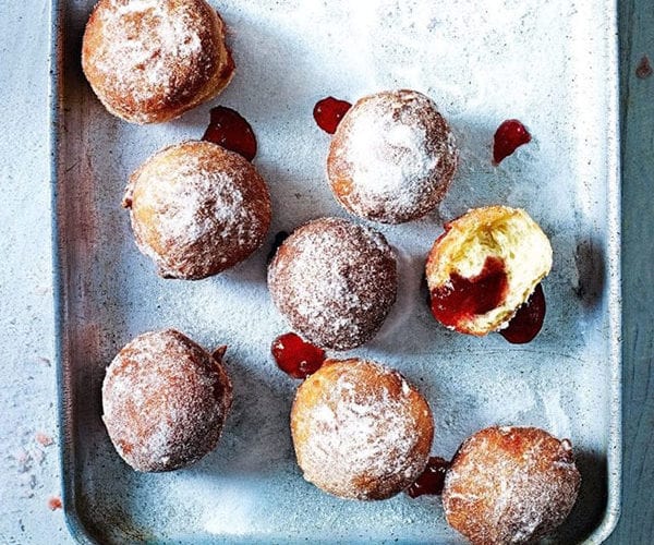 Cooked and filled jam doughnuts shown on a tray