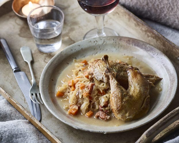 Pot roast pheasant shown on a speckled grey plate