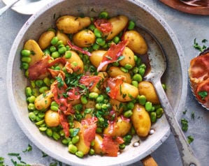 Sherry braised jersey royals with broad beans and serrano ham