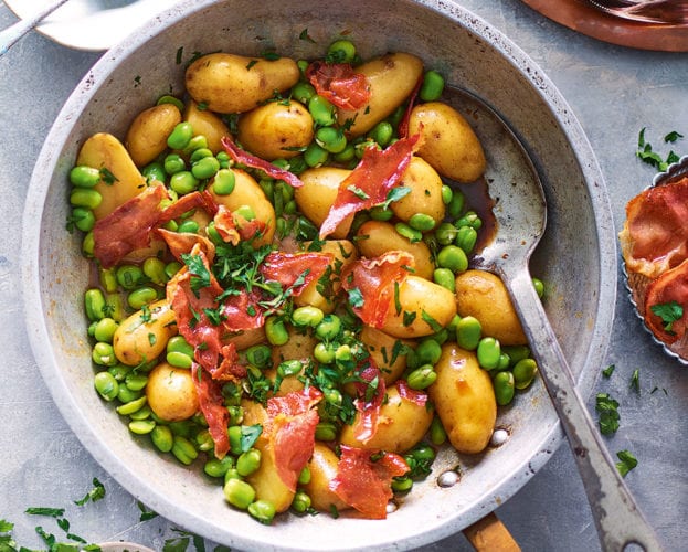 Sherry braised jersey royals with broad beans and serrano ham