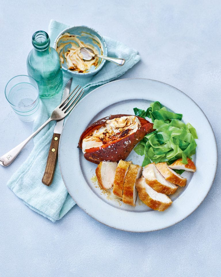 Crispy-skinned chicken breasts with baked sweet potatoes and chipotle cream