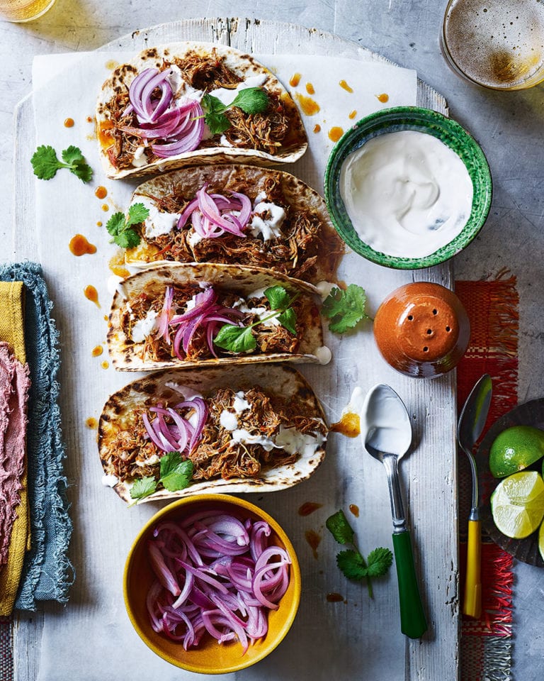 Slow-cooked chicken tinga tacos with pickled onions