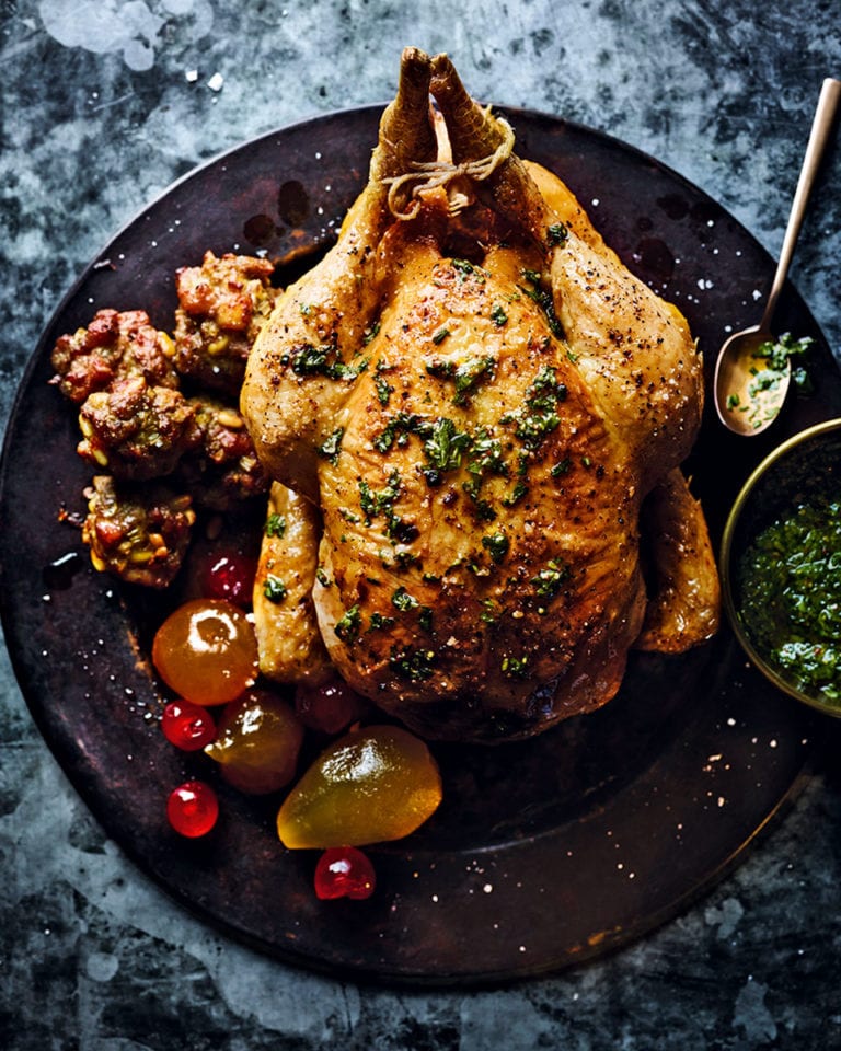 Roast stuffed chicken with mustard fruits and green sauce