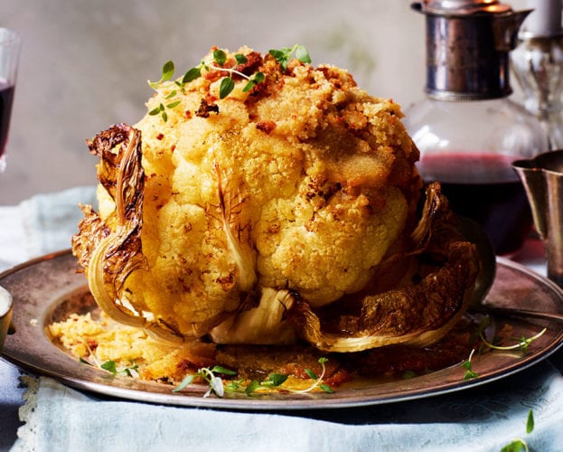 Whole roasted cauliflower with leeks and cheese sauce